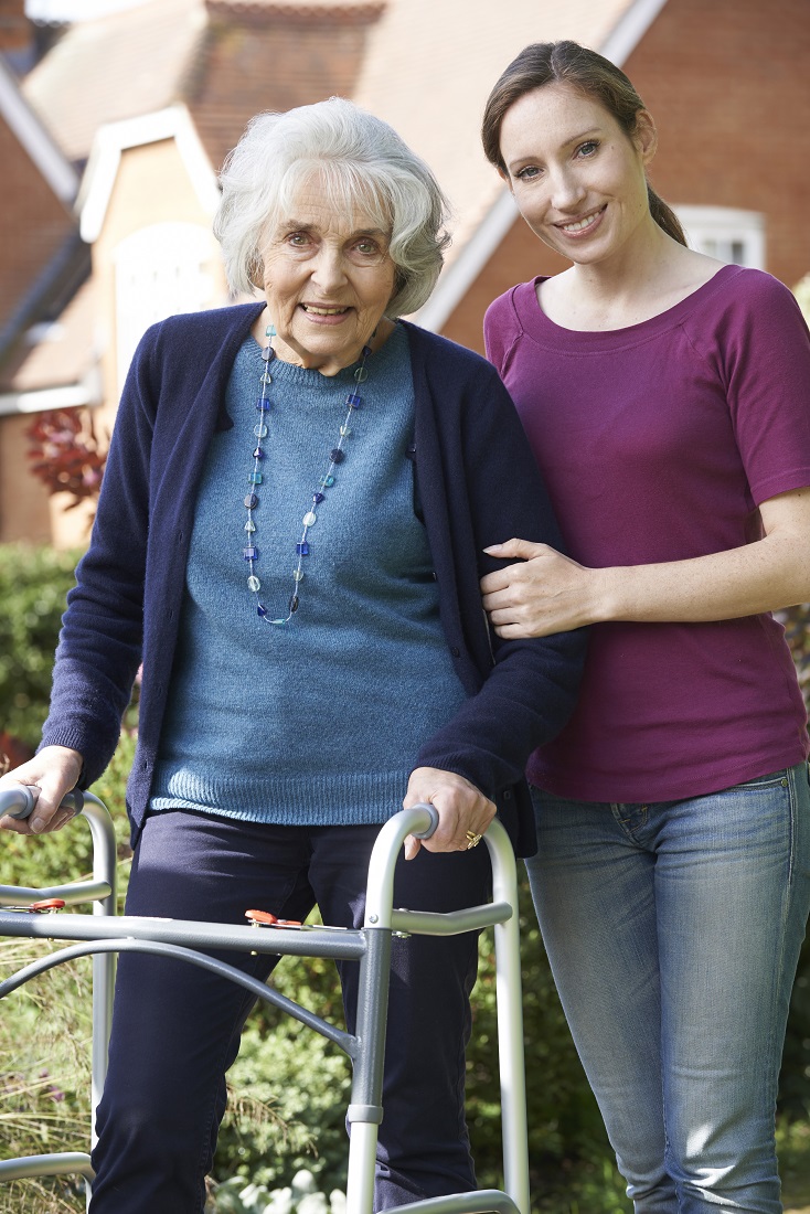 elderly-woman-using-walker-with-aide-2.jpg